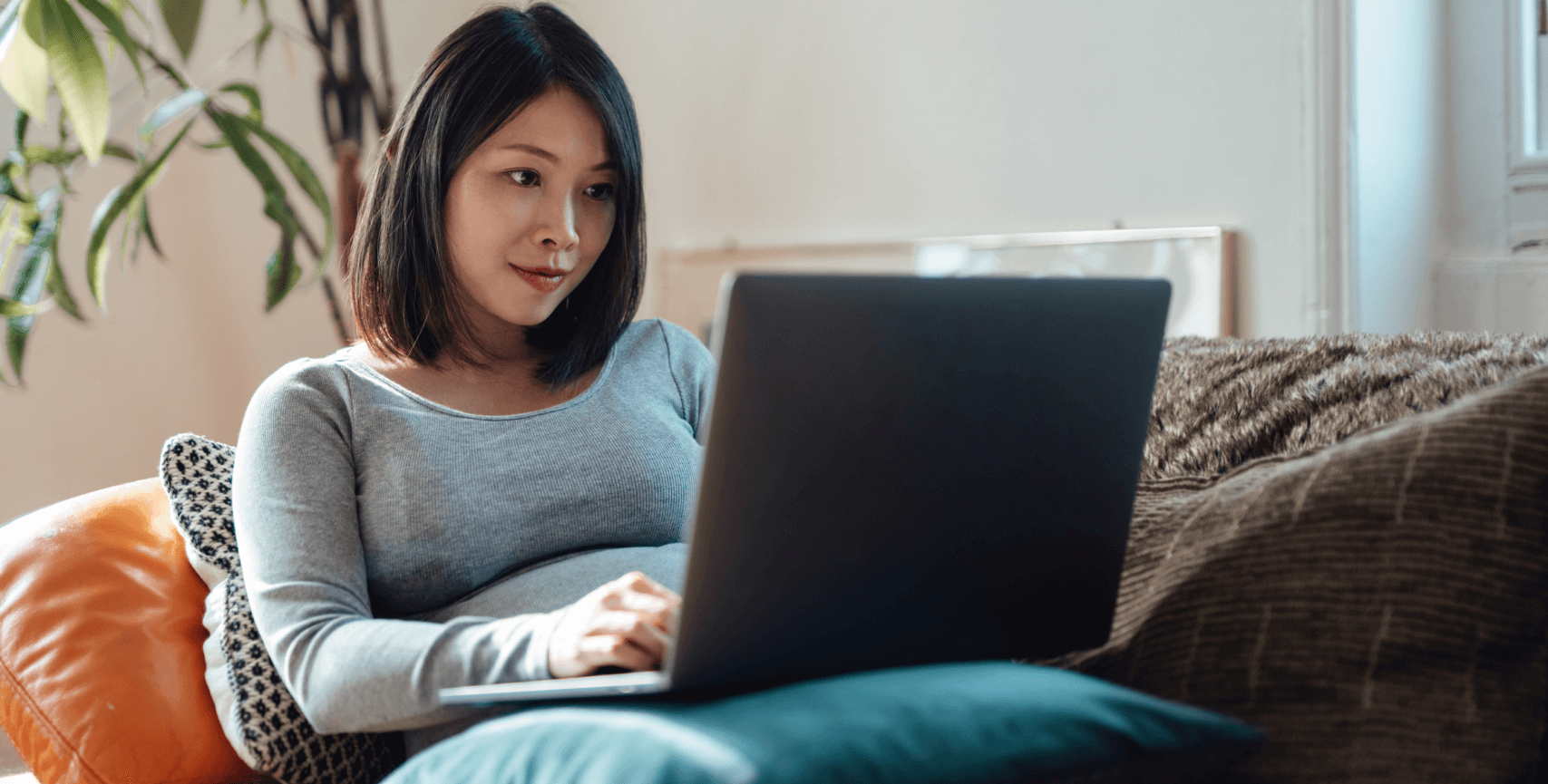 woman-on-sofa-looking-at-laptop