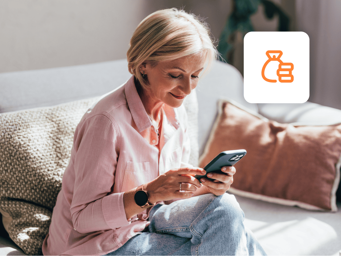 woman-pink-shirt-on-couch-looking-at-mobile