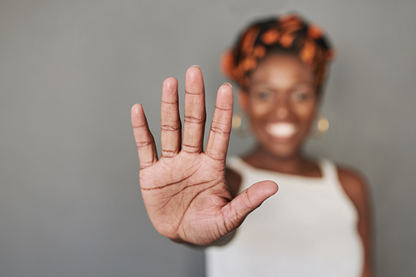 A woman holding up five fingers