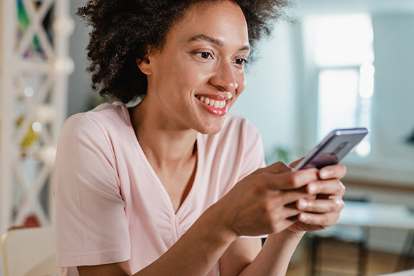 Investor considering shares on phone