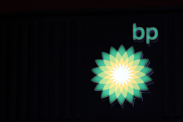 Illuminated BP logo against black background, Getty