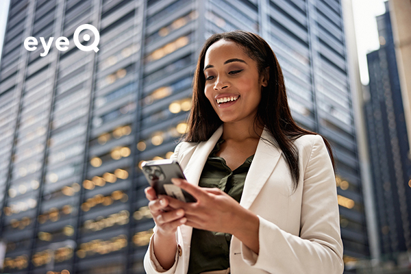 eyeQ Woman smiling and looking at phone