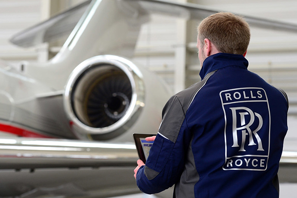 Rolls-Royce logo on work shirt in front of jet, Flickr