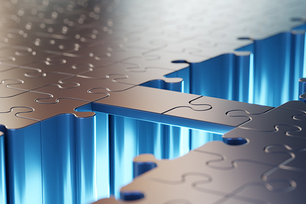 Abstract bridge made with two puzzle pieces across empty space 