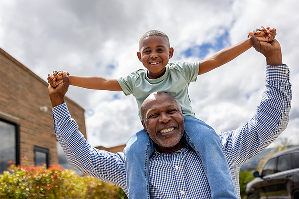 Grandson on grandfather's shoulders