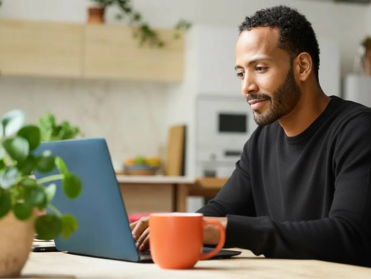 man on laptop with drink (002)
