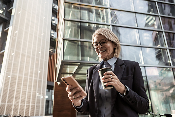 Woman reading about shares on smartphone