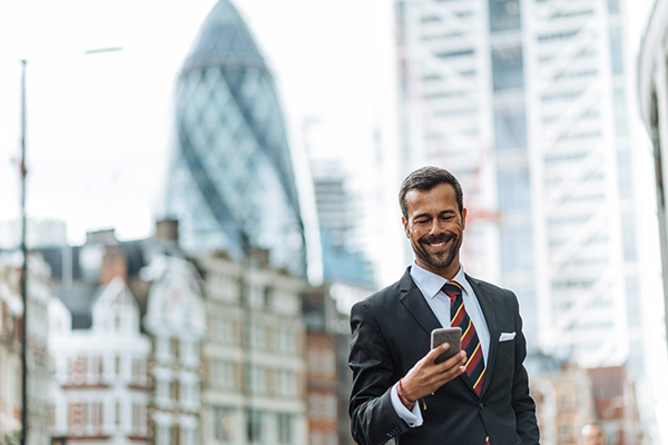 Man looking at phone in the City of London