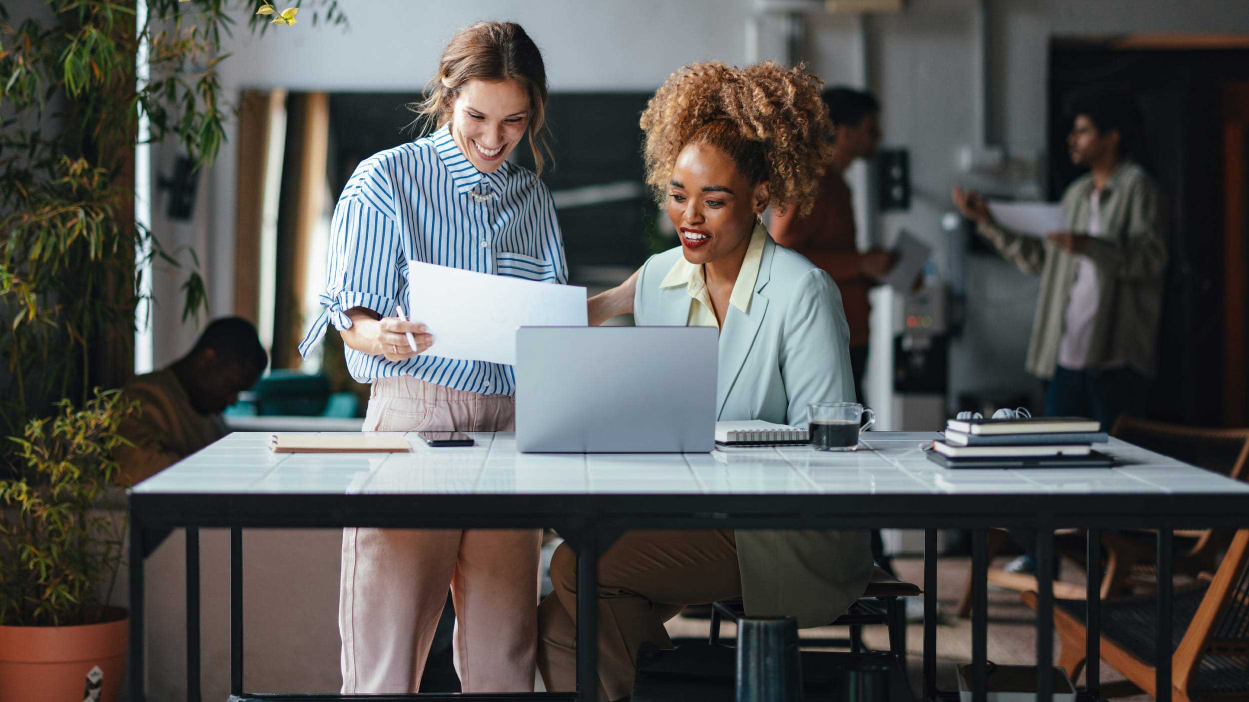 Women at desk looking at documents