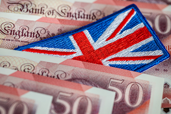 Union flag badge among £50 banknotes