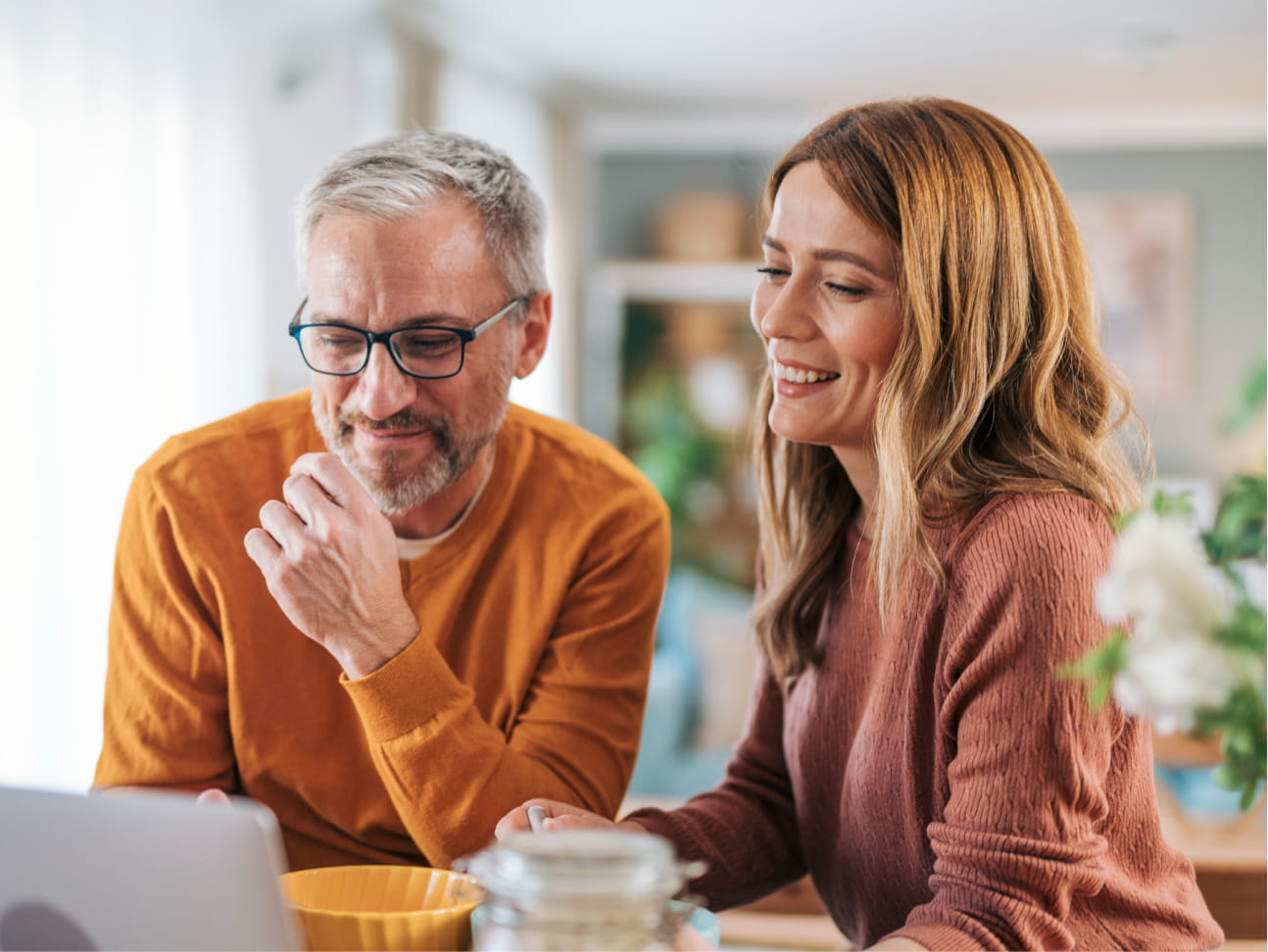 Couple viewing pension savings on laptop