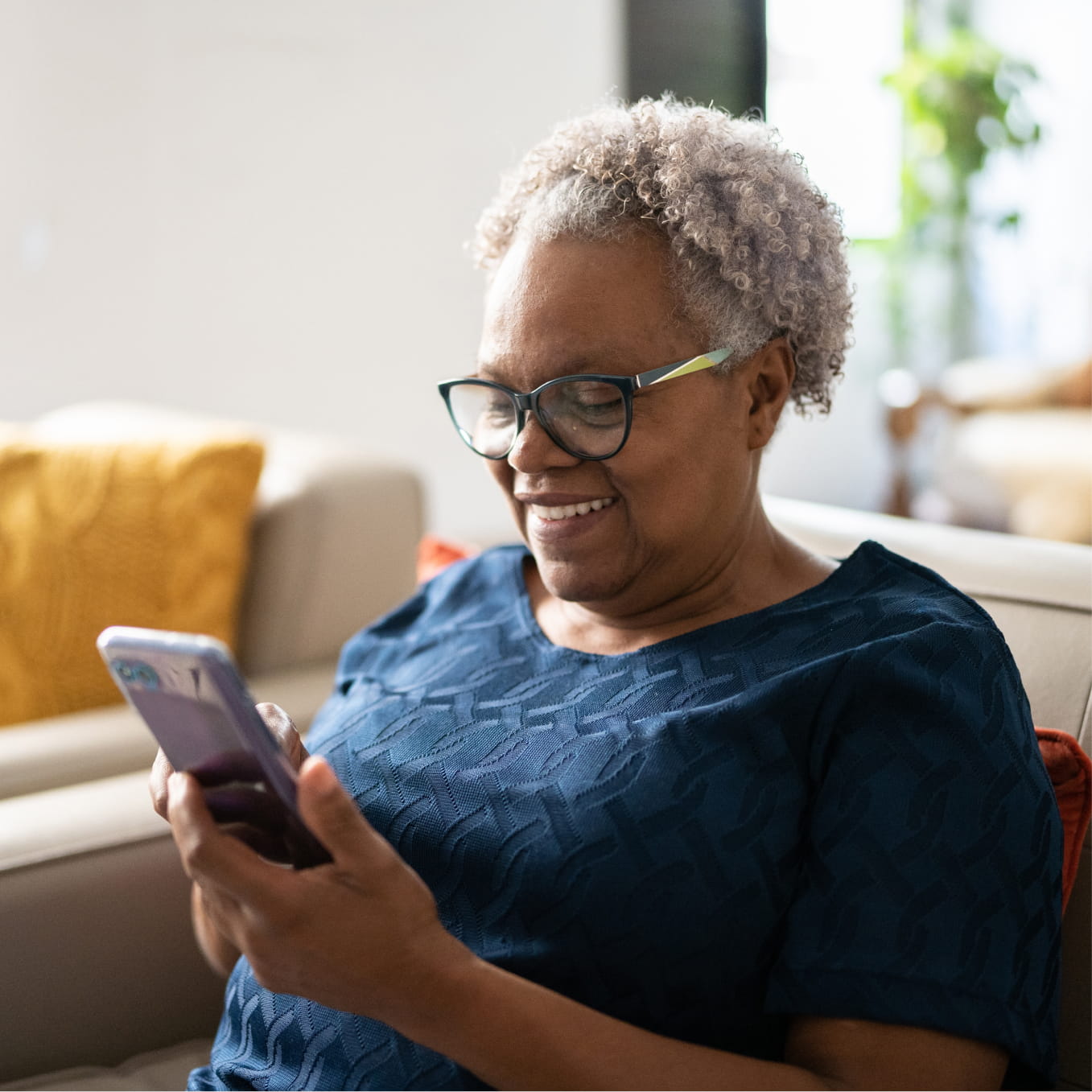 Mature woman smiling at mobile