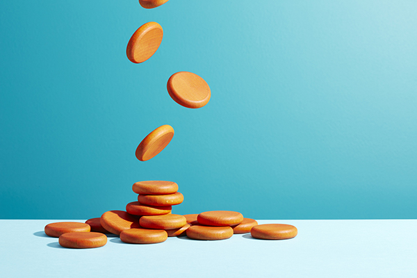 Orange coins falling against blue background
