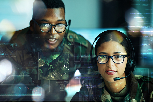 Military personnel with headsets and intelligence screen