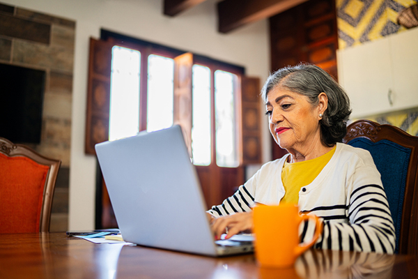 Woman sitting looking at laptop