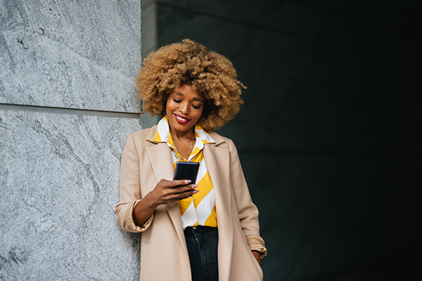 Female investor reading smartphone