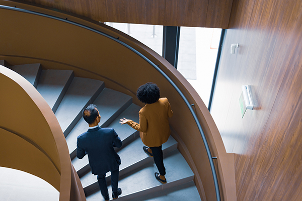 Business as usual with colleagues walking up a staircase