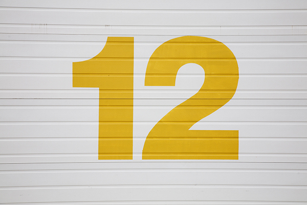 Yellow number 12 on white background