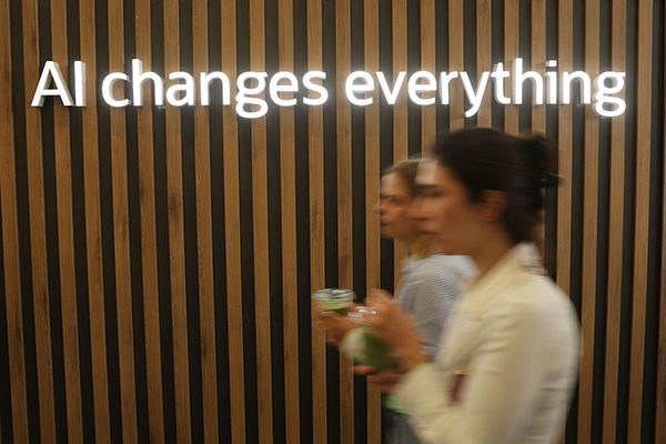 'AI changes everything' sign at trade fair, Getty