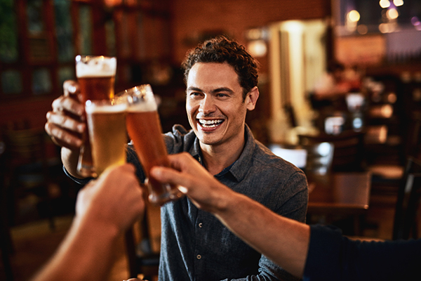 Man surrounded by beers in a pub