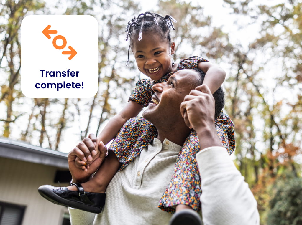 Happy father with young daughter laughing on his shoulders outdoors with a transfer complete icon