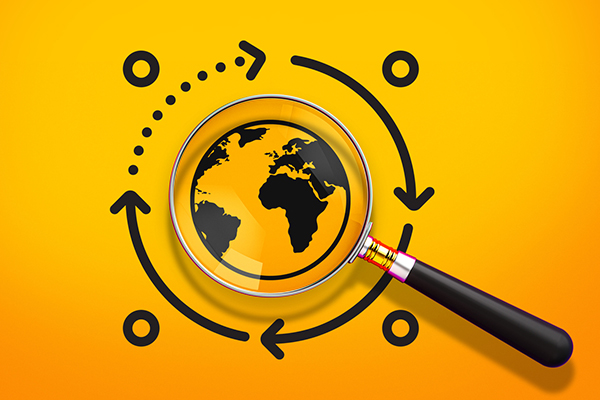 A magnifying glass focuses on a world globe 