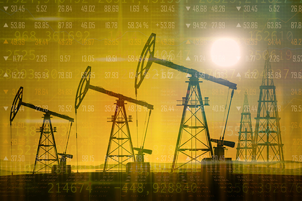 Oil pumpjacks against financial data background