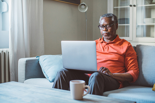 Man looking at gilts and bonds on a laptop