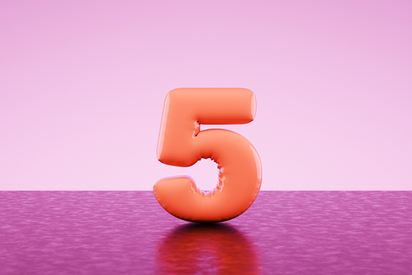 Squishy orange number 5 against a pink background