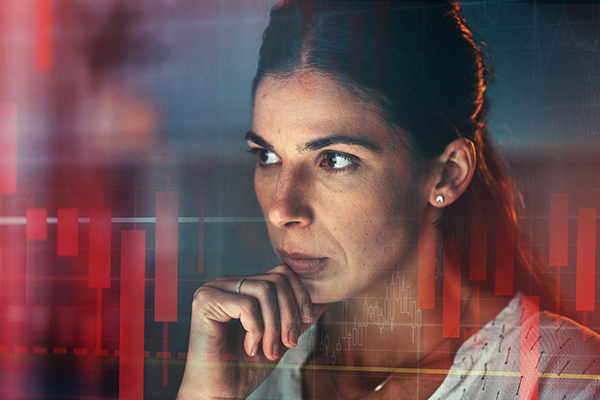 Worried looking woman against market chart