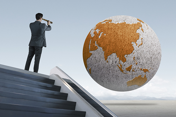 Man viewing globe through telescope