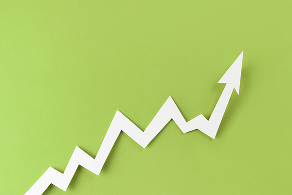 White growth arrow against lime-green background