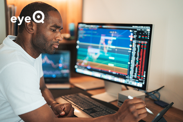 eyeQ a trader studying a chart on a screen