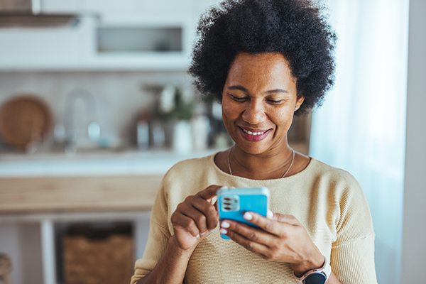 A woman looking at a share on her smartphone