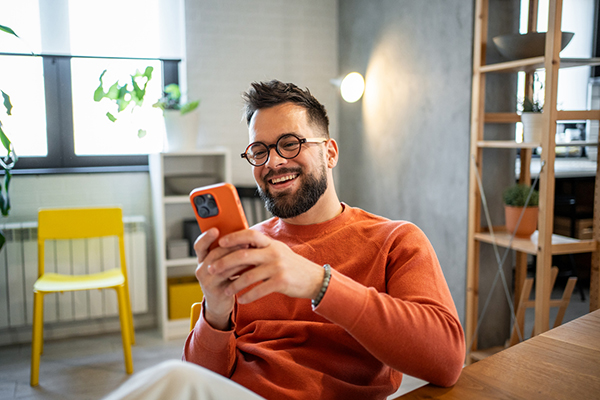 Man considering a trade on his smartphone