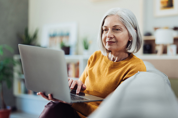 Pensioner reading tax tips online
