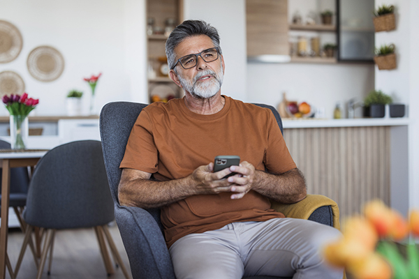 Man thinking about ISA changes looking at smartphone