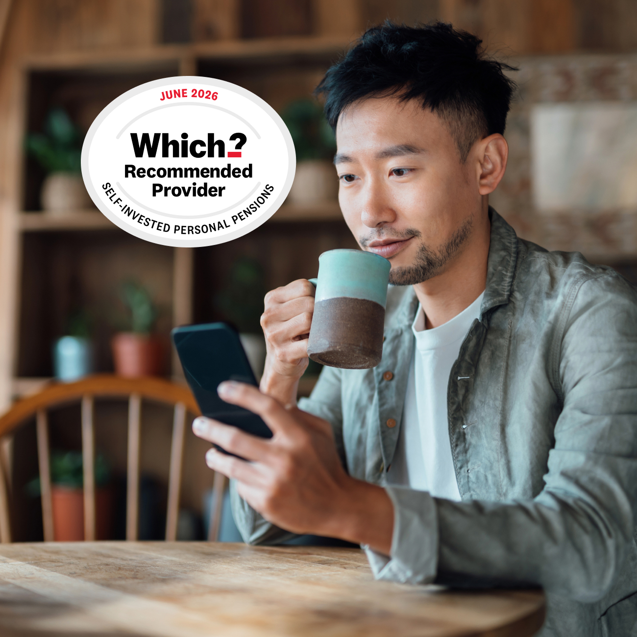 Man looks at smartphone with Which Award