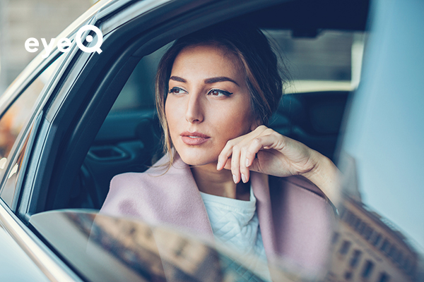 eyeQ Woman looking out of a car window