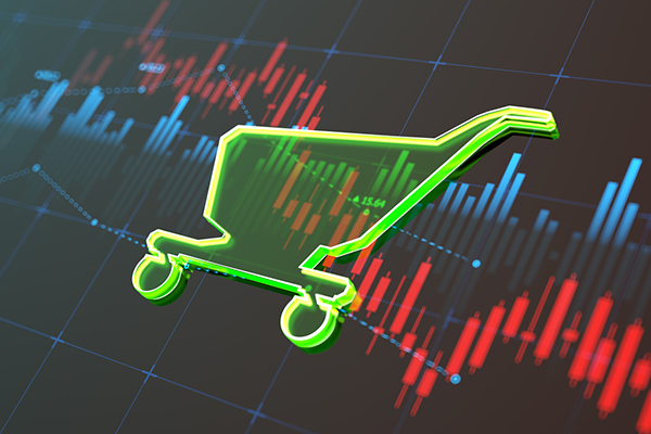Shopping trolley against market chart