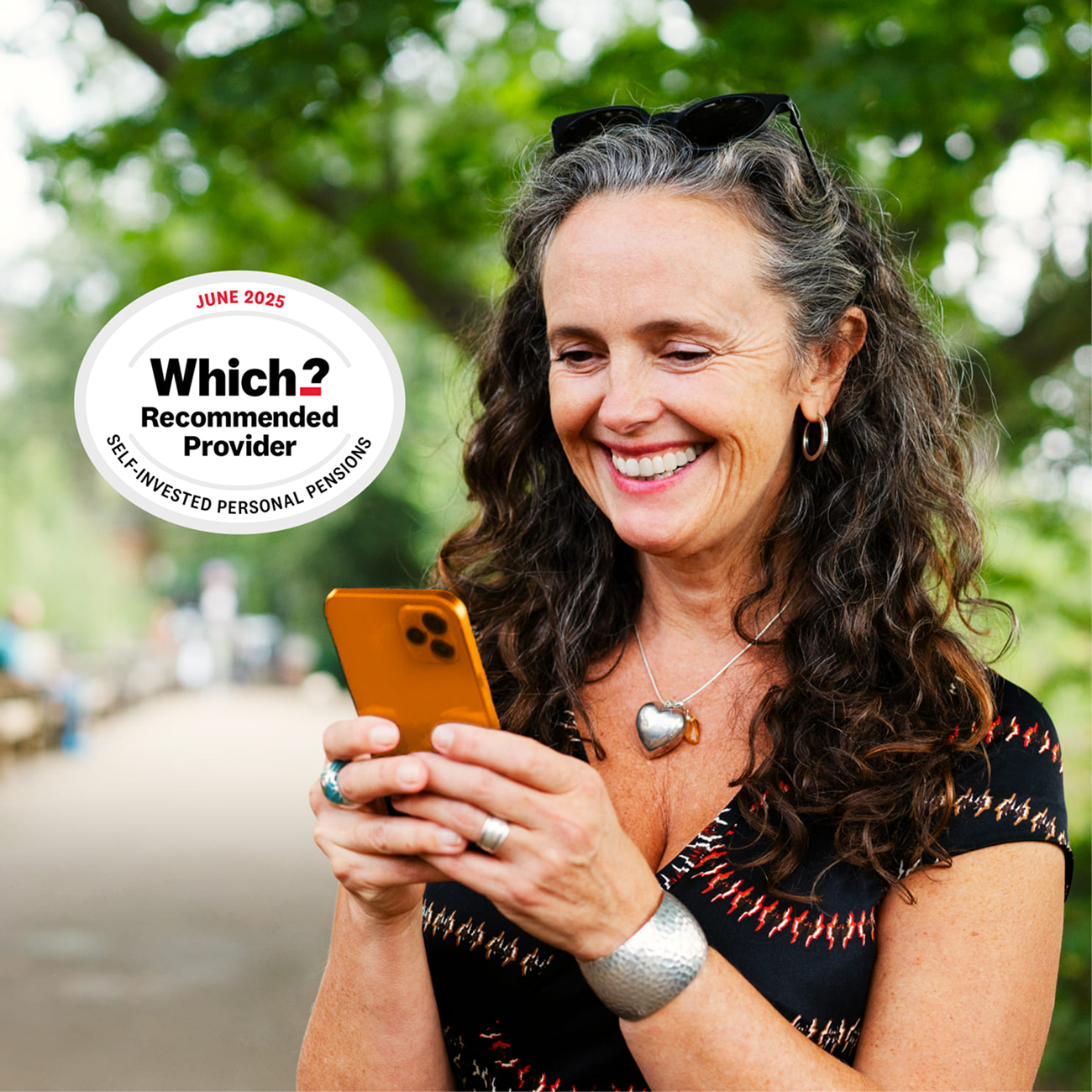 Woman outdoors smiling at her mobile with Which? Recommended Provider award
