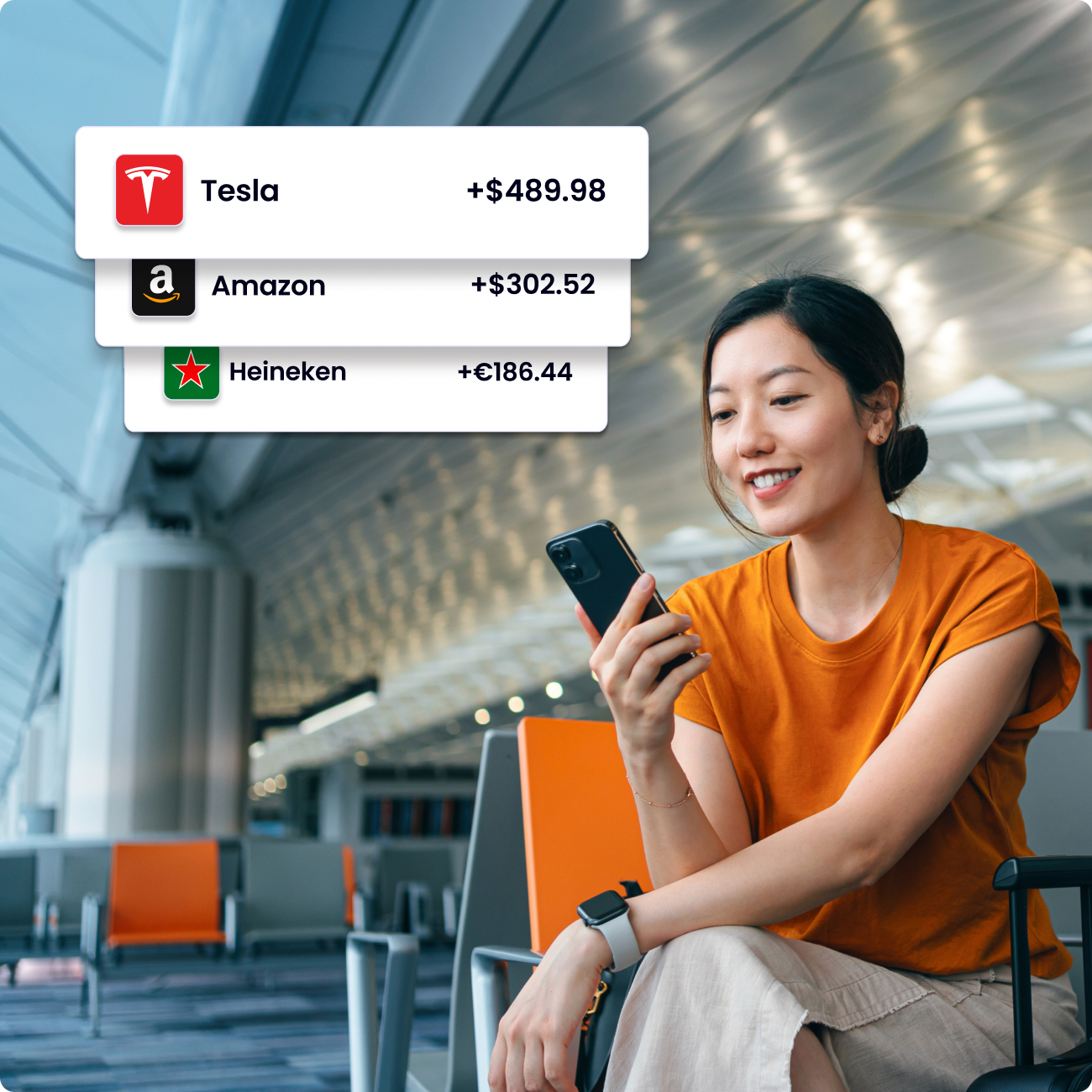 Woman sitting in an airport with graphics showing Tesla, Amazon, and Heineken.
