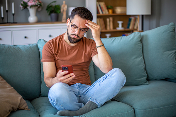 Investor puzzling and sitting crosslegged on sofa