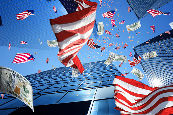 US dollars and flags against skyscrapers and blue sky