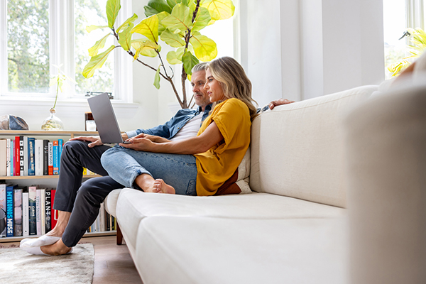 Couple looking at pension on laptop
