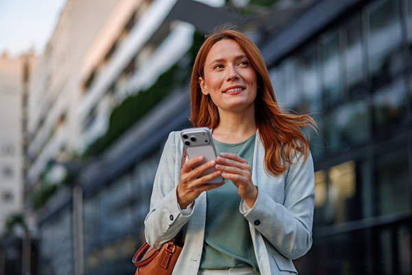 Woman considering a trade on her phone