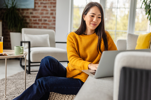 Woman reading about ISAs at home on her laptop
