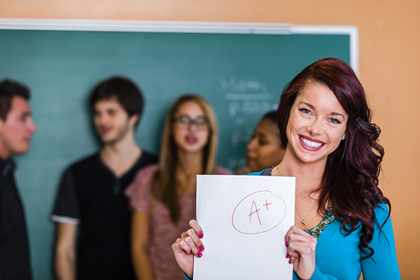 Woman showing top grade on paper