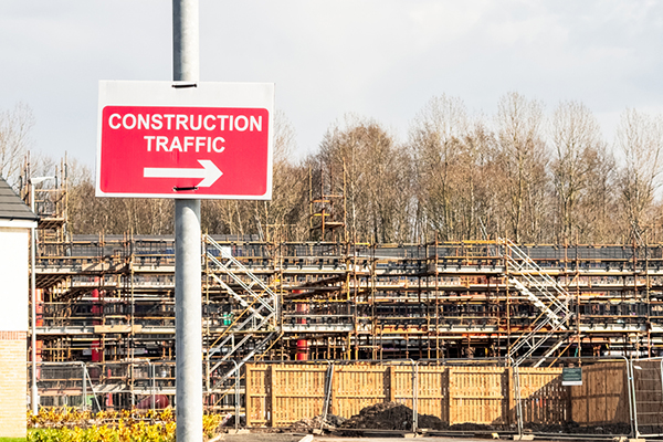 Housing construction site and sign for traffic