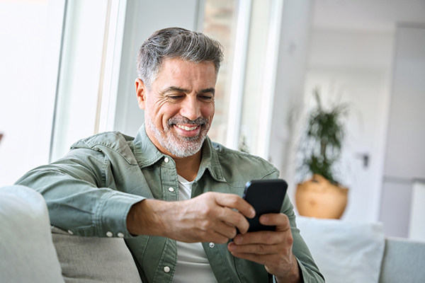 Man looking at his phone on the sofa